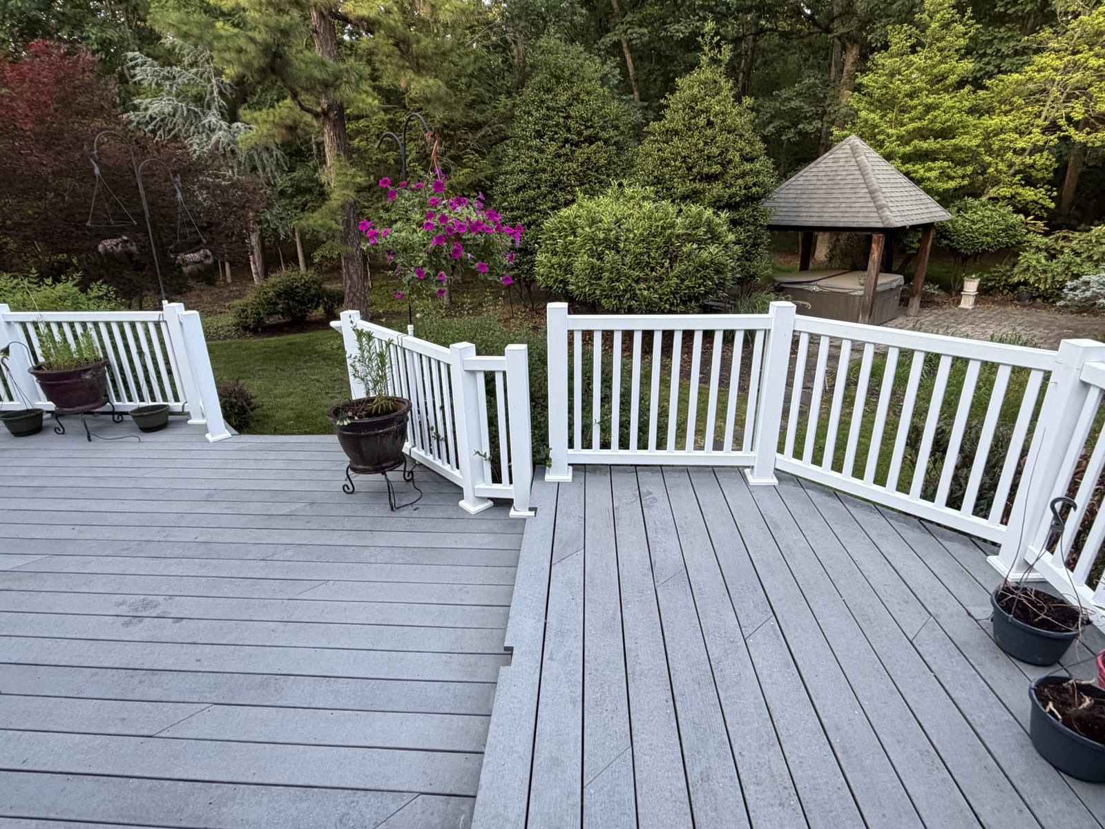 Cleaned back deck and white railing by Puresplash Services